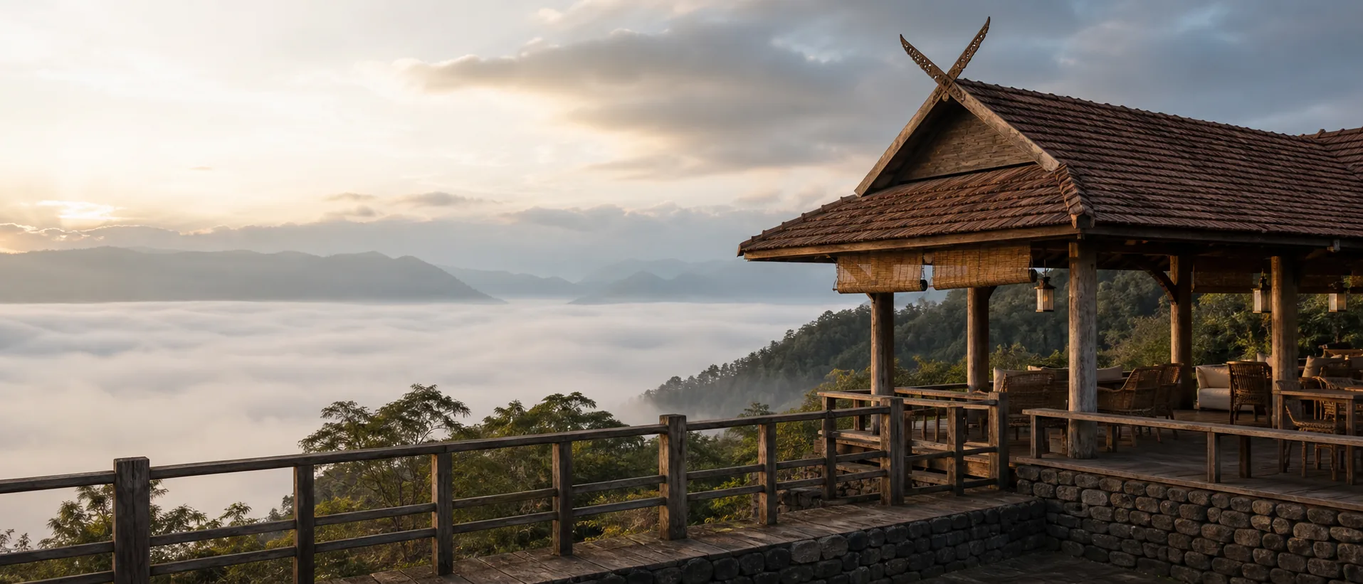 Mountaintop terrace of a Lanna-style cafe above a sea of fog at golden hour